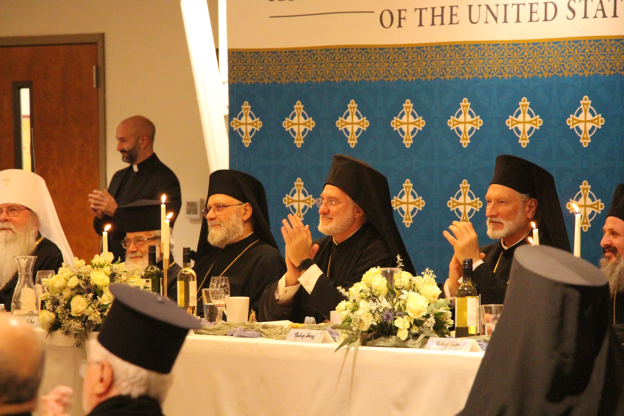 Met. Saba (Antiochian), Abp. Elpidophoros (Greek), and Bsp. Irinej (Serbian) watch a dance troupe at a reception during the recent Assembly of Bishops events in Denver. Photo: Aaron Hickman/UOJ-USA