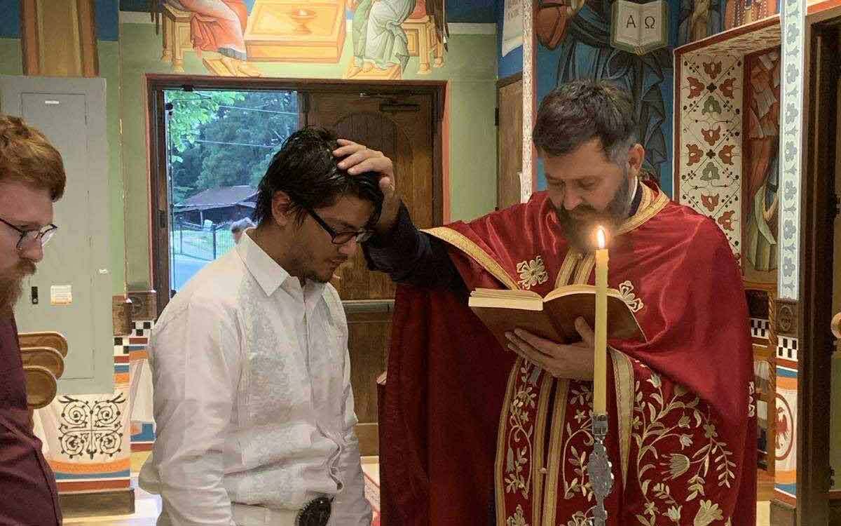 Fr. Srebrenko receives a parishioner into Holy Orthodoxy. Photo: Serbian Diocese of Eastern America