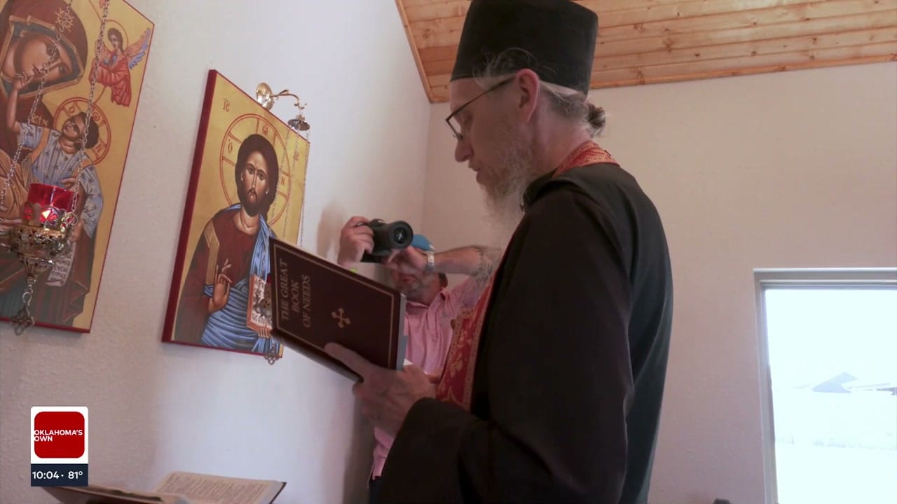 The Teague's parish priest blesses the new chapel. 