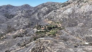 The historic Nea Moni Monastery remains unscathed in the center of a landscape that was once covered in greenery. Photo: Konstantinos Anagnostou/Reuters