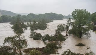Trees emerge from flood waters along the Guadalupe River on Friday in Kerrville, Texas. Photo: Eric Vryn/Getty Images