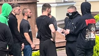OCU militants receiving instructions from a coordinator on UOC cathedral grounds. [CREDIT: UOJ/SPZh]