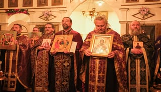 Clergy hold icons during the reading of the Synodikon of the Seventh Ecumenical Council in Galveston on Sunday. Photo: Cory Meissner