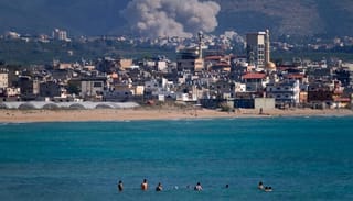 An Israeli airstrike hits the Qlaileh village (background), as seen from the port city of Tyre, Lebanon. Photo: religionnews.com