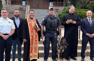Police and seminary staff with the returned relics of St. Raphael