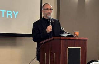 Fr. Peter Spiro speaks in Aurora. Photo: Dr. Rodney Caniglia