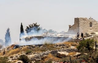 A fire burns next to the archaeological site of the ruins of the Church of St. George in the West Bank town of Taybeh. Photo: Nabd ElHaya online radio station