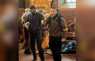 Pshenychny aiming a pistol at parishioners in the Cherkasy cathedral. Photo: Telegram channel of Yevhen Karas