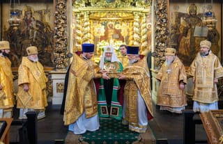 Pat. Kirill stands before the relics of St. Tikhon. Photo: ROC Commission for the Development of Pilgrimage and the Bringing of Holy Relics