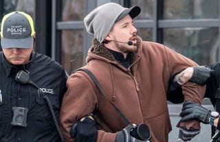 Derek Reimer is escorted away from an all-ages drag brunch in January 2023. He was later arrested and charged with hate-motivated crimes after disrupting storytime events in February and