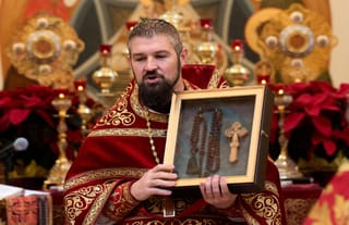 Fr. Gabriel Bilas with the prayer rope and blessing cross. Photo: St. Mary Magdalene Orthodox Church/Facebook