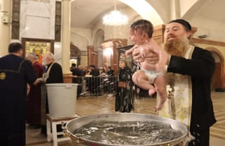 A child is baptized in Georgia on Nov. 23, 2025. Photo: Orthodoxia News Agency