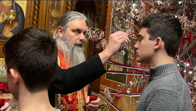 One of the youth receives Holy Unction from Bishop Serafim. Photo: Youth of the New Gracanica - Midwest Diocese/Facebook