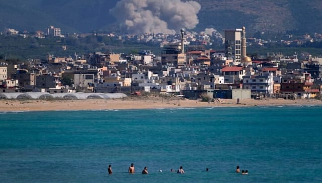 An Israeli airstrike hits the Qlaileh village (background), as seen from the port city of Tyre, Lebanon. Photo: religionnews.com