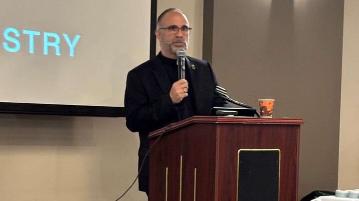 Fr. Peter Spiro speaks in Aurora. Photo: Dr. Rodney Caniglia