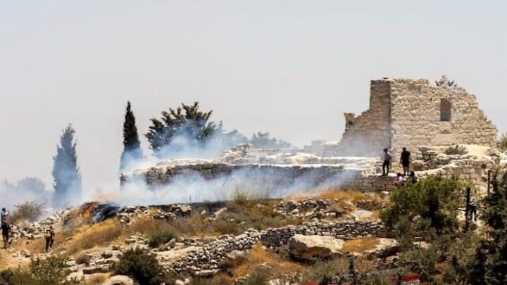 A fire burns next to the archaeological site of the ruins of the Church of St. George in the West Bank town of Taybeh. Photo: Nabd ElHaya online radio station