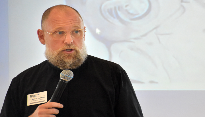 Fr. Justin Mathews speaks during an event for Reconciliation Services. Photo: Taylor Wilmore/Startland News